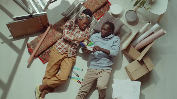 African American Couple Discussing Color Palette while Renovating House