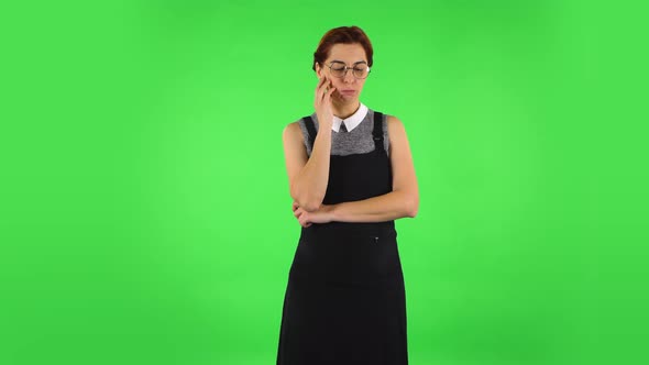 Funny Girl in Round Glasses Is Focused Thinking About Something, No Idea. Green Screen