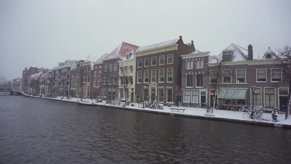 Leiden town in Netherlands, Rhine riverside buildings in winter snow