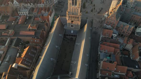 Flying over Belfry of Bruges to reveal city