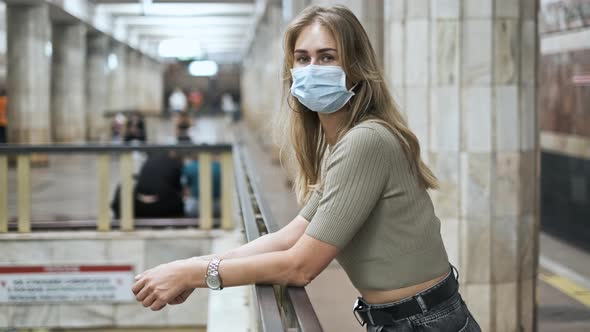 Masked Passenger Waiting Train Subway Corona Virus. Girl Look at Camera Covid-19