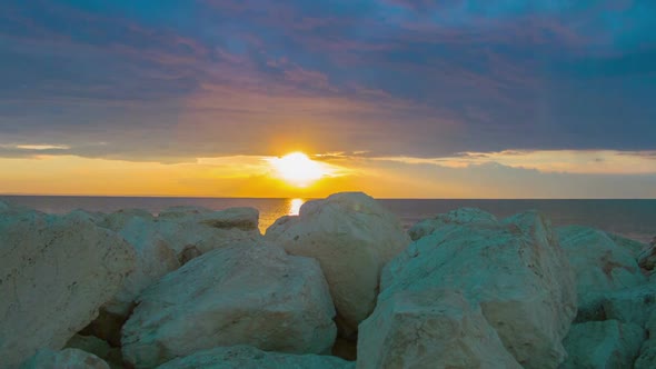 Timelapse of Fantastic Sunrise Over Sea. White Stones on Coast