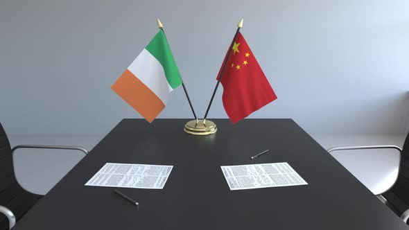 Flags of Ireland and China and Papers on the Table alt