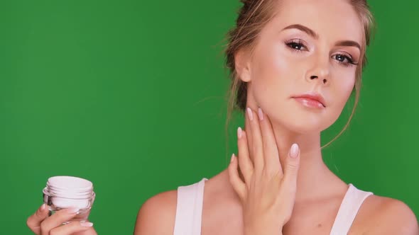 Girl with Perfect Skin Smoothing Cream on Her Neck