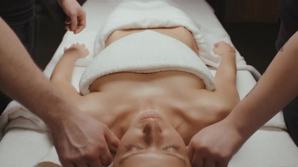 Slim Brunette Woman Receiving Health Shoulder and Body Rejuvenating Massage Procedure in Spa Center