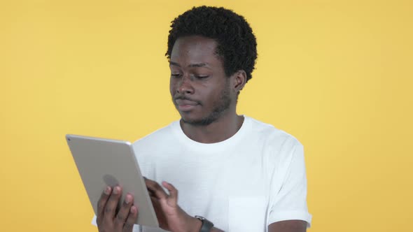 African Man Browsing Internet, Using Tablet