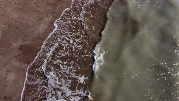 Muddy Sea Water on a Sandy Beach