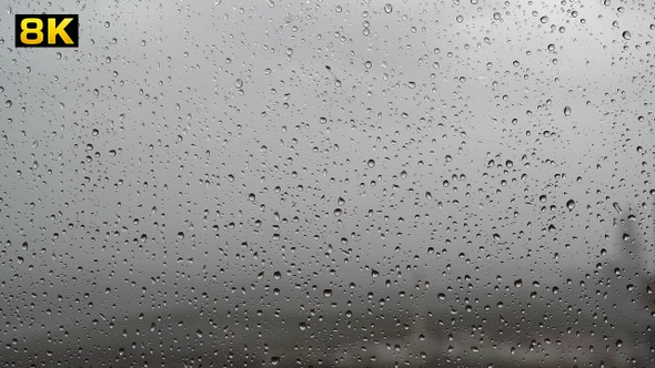 Water Drops of Rain on Wet Window Glass Surface