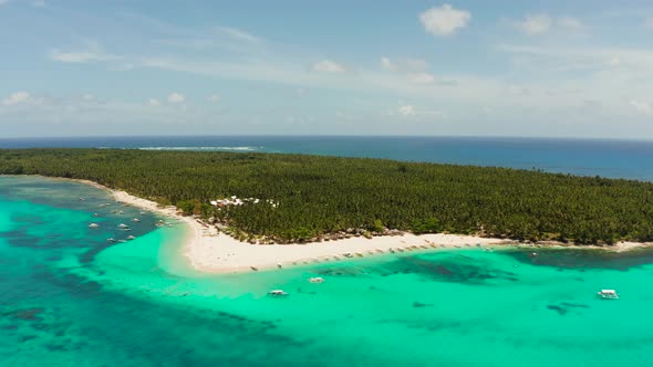 Tropical Daco Island with a Sandy Beach and Tourists