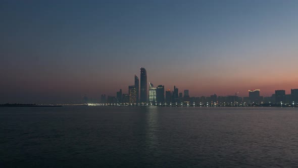 Abu Dhabi City Skyline at Sunrise Night To Day Transition Timelapse