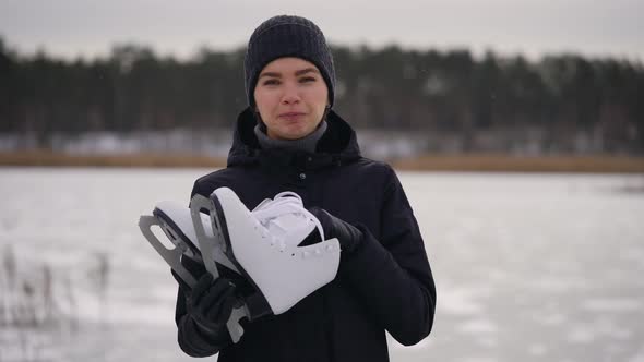 A Young Woman in a Dark Jacket Came To the Frozen Lake To Go Ice Skating