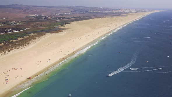 Very high drone perspective on extreme sports - kitesurfing beach tarifa