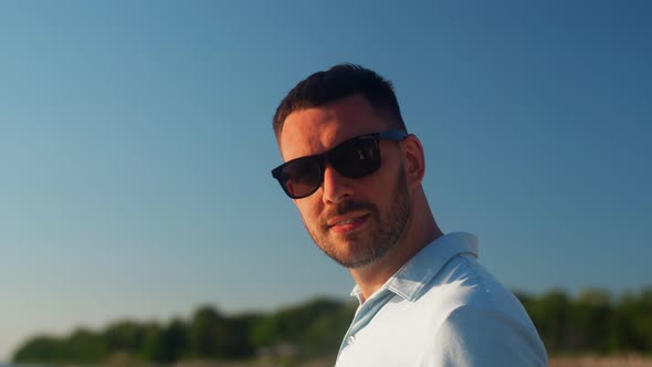 Smiling Man in Sunglasses on Summer Beach