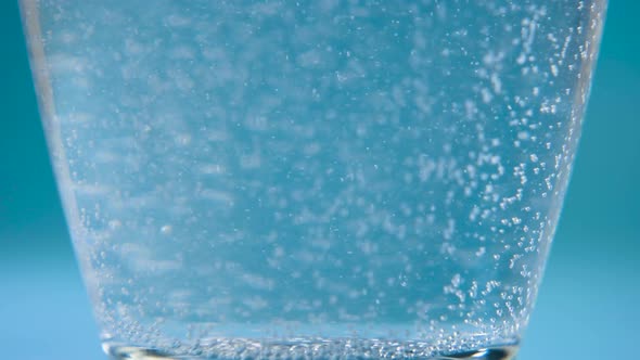 Bubbles Rise From the Bottom in a Glass Cup