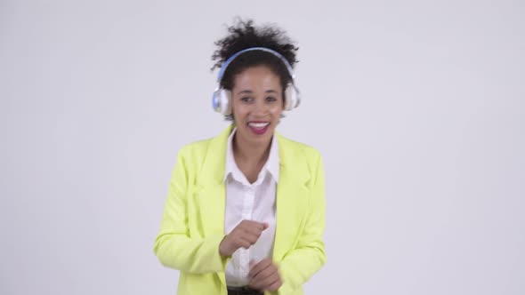 Happy Young Beautiful African Businesswoman Dancing and Listening To Music