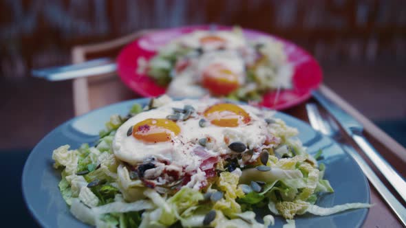 Two portions of healthy salad with eggs and smoked chilli. Clip represents healthy paleo eating and