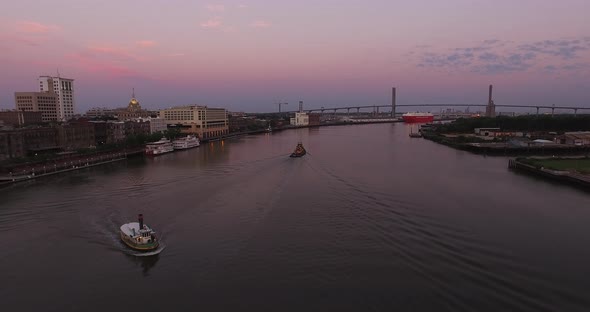 Tugboats on Savannah River with City and Bridge