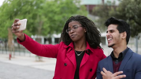 Woman and Man Making Selfie Outside, Man Making Faces, Posing