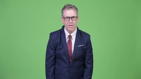 Studio Shot of Mature Businessman Looking Shocked