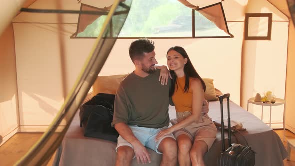 Couple Posing Sitting on Bed