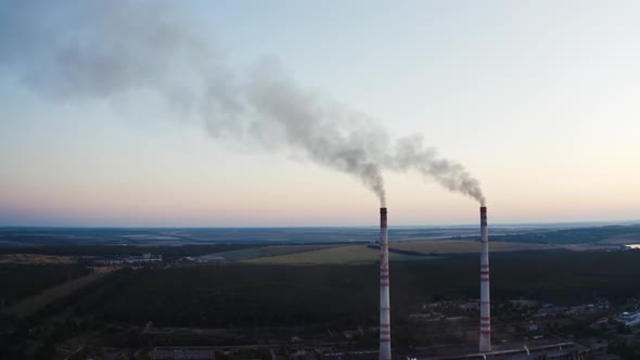 Two pipes with smoke on the beautiful landscape of nature. 