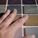 The Designer's Hand Runs His Fingertips Over the Painted Wood Samples - VideoHive Item for Sale