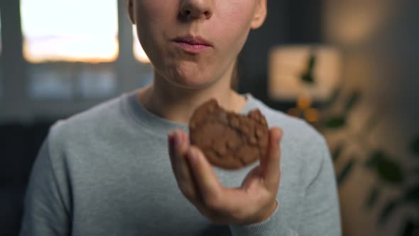 Woman Eats a Chocolate Chip Cookies