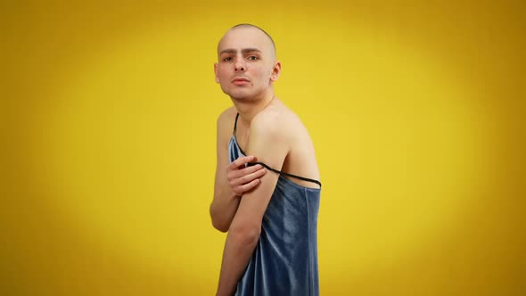 Side View Portrait of Young Male Queer Putting Dress Strap on Shoulder Looking at Camera