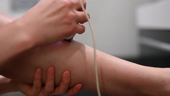 Woman Doing Leg Heir Depilalation Using Electric Depilator