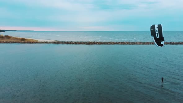 Aerial Drone View of a Corekites Kitesurfers Hydrofoiling  in Engure Port at in Baltic Sea