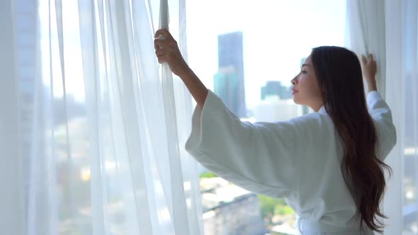 Asian woman relax on bed in bedroom interior