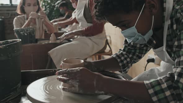 Boy in Mask Making Craft of Clay