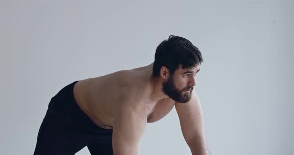 Bearded Guy Exercising with Dumbbell at Home, Close Up