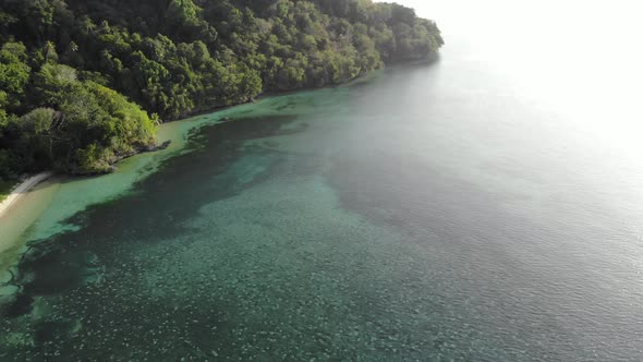 Aerial: flying over tropical white sand beach Banda Islands Maluku Indonesia