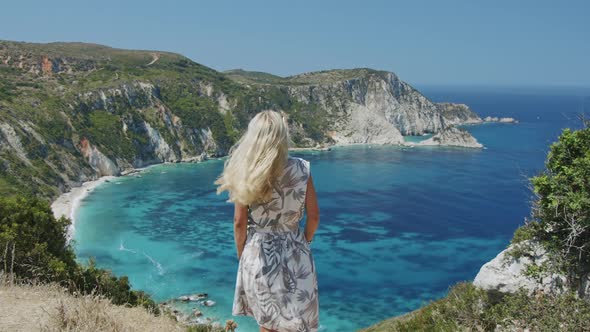 Blond Woman Waving Her Hair and Put the Sun Hat on