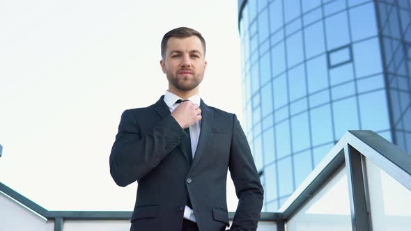 A Well Dressed Happy Bearded Office Corporate Male Executive Standing Outside a Modern Corporate