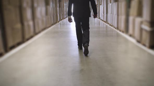 Businessman walking in warehouse