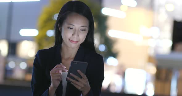 Businesswoman Use of Smart Phone in Hong Kong City at Night