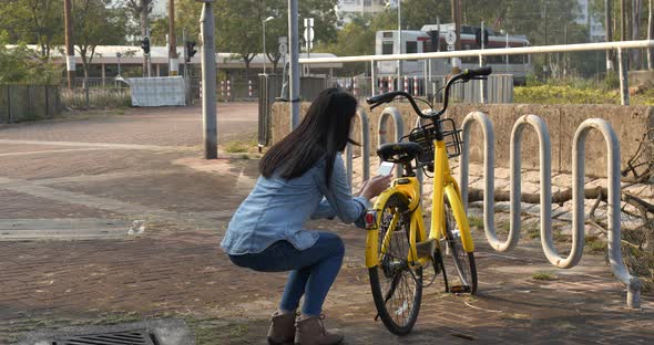 Woman Using Share Bike in The City