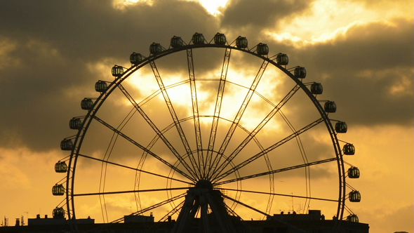 Ferris Wheel at Sunset in Cloudy Day