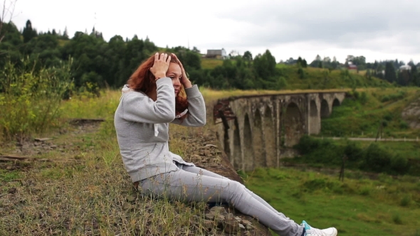 Girl Sitting On The Old Viaduct