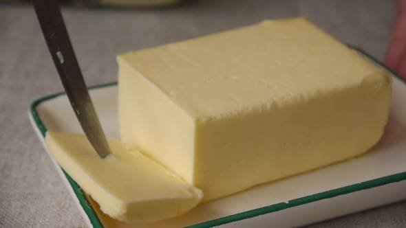 Cutting Off A Piece Of Butter