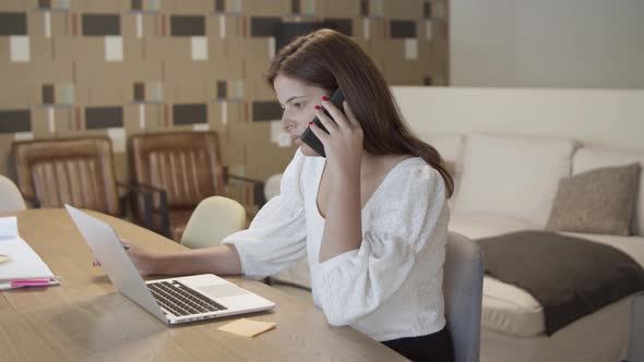 Focused Female Professional Talking on Cell