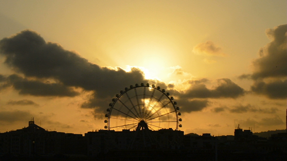 Ferris Wheel Spinning in Skyline at Sunset