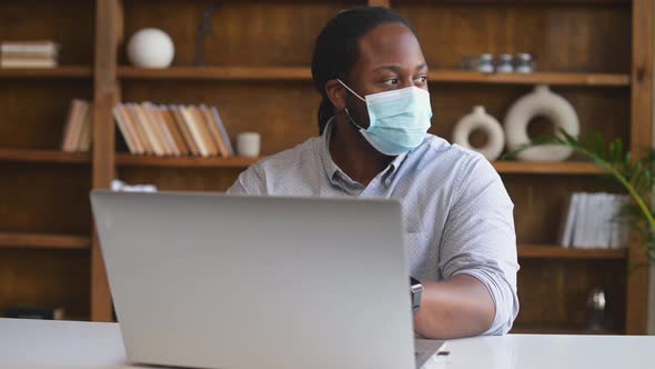 An AfricanAmerican Male Office Employee Wearing Medical Mask Indoor