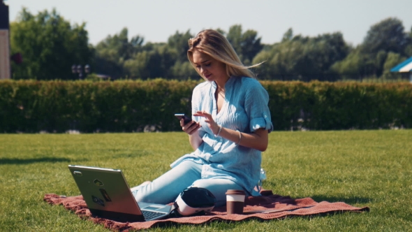 Attractive Young Woman Using VR In Park