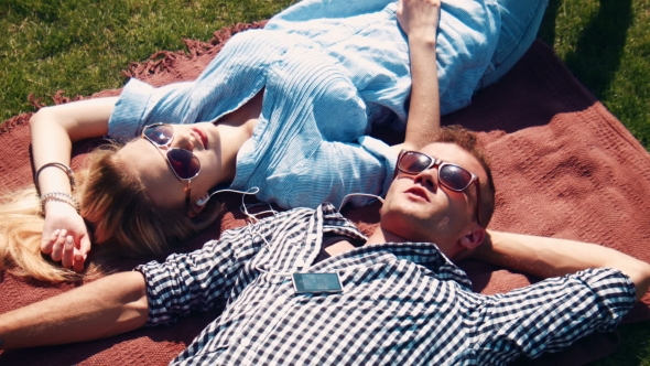 Attractive Young Couple Relaxing In The Summer Sun