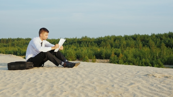 Businessman in Business Suit Reading Documents