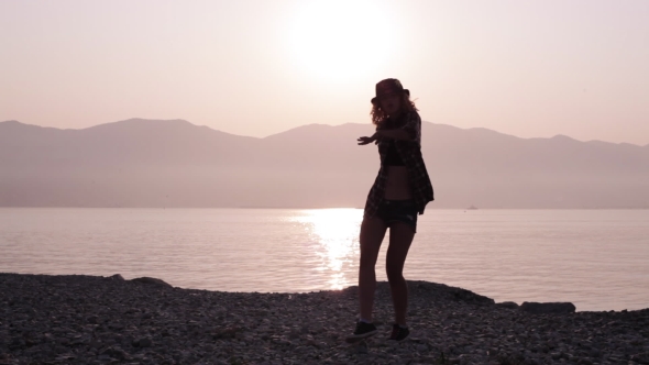 Silhouette Of a Dancing Teen Girl At Sunrise