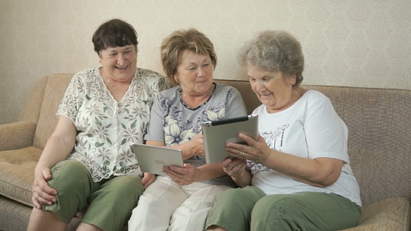 Elderly Women Holding Digital Tablets At Home